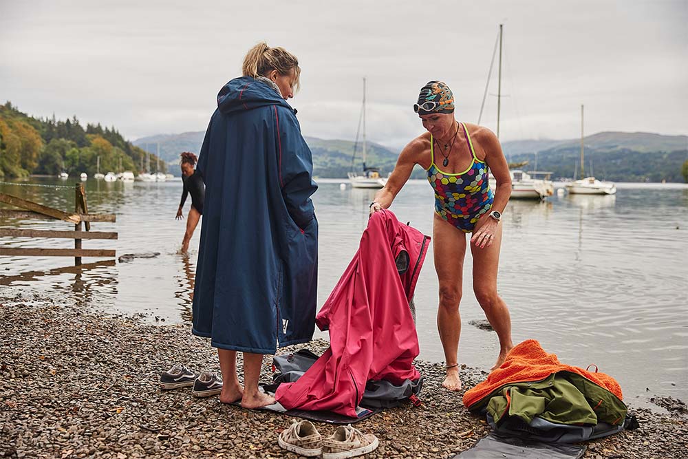 Women swimming putting on Red Original waterproof changing robes