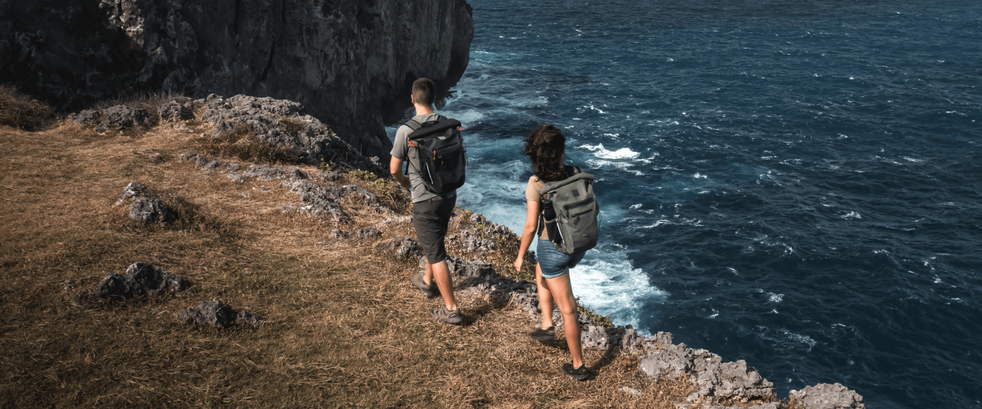 man and woman hiking with waterproof backpacks