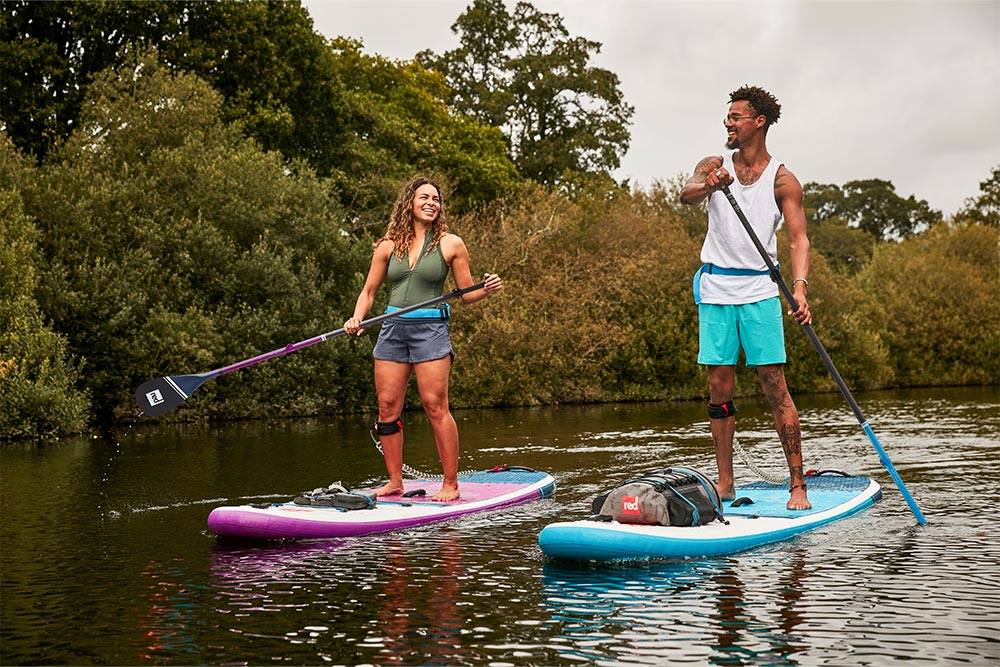 Man and woman paddling Red Original 10'6" SUP