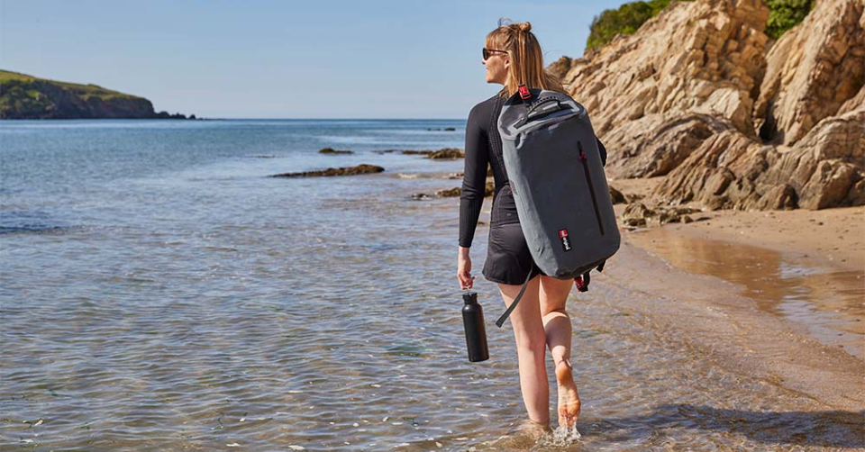 Woman carrying Red Original Waterproof Kit Bag 