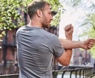 Man stretching wearing Red Original performance t-shirt