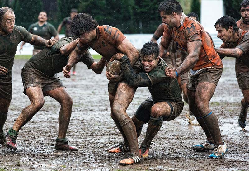 rugby players in mud