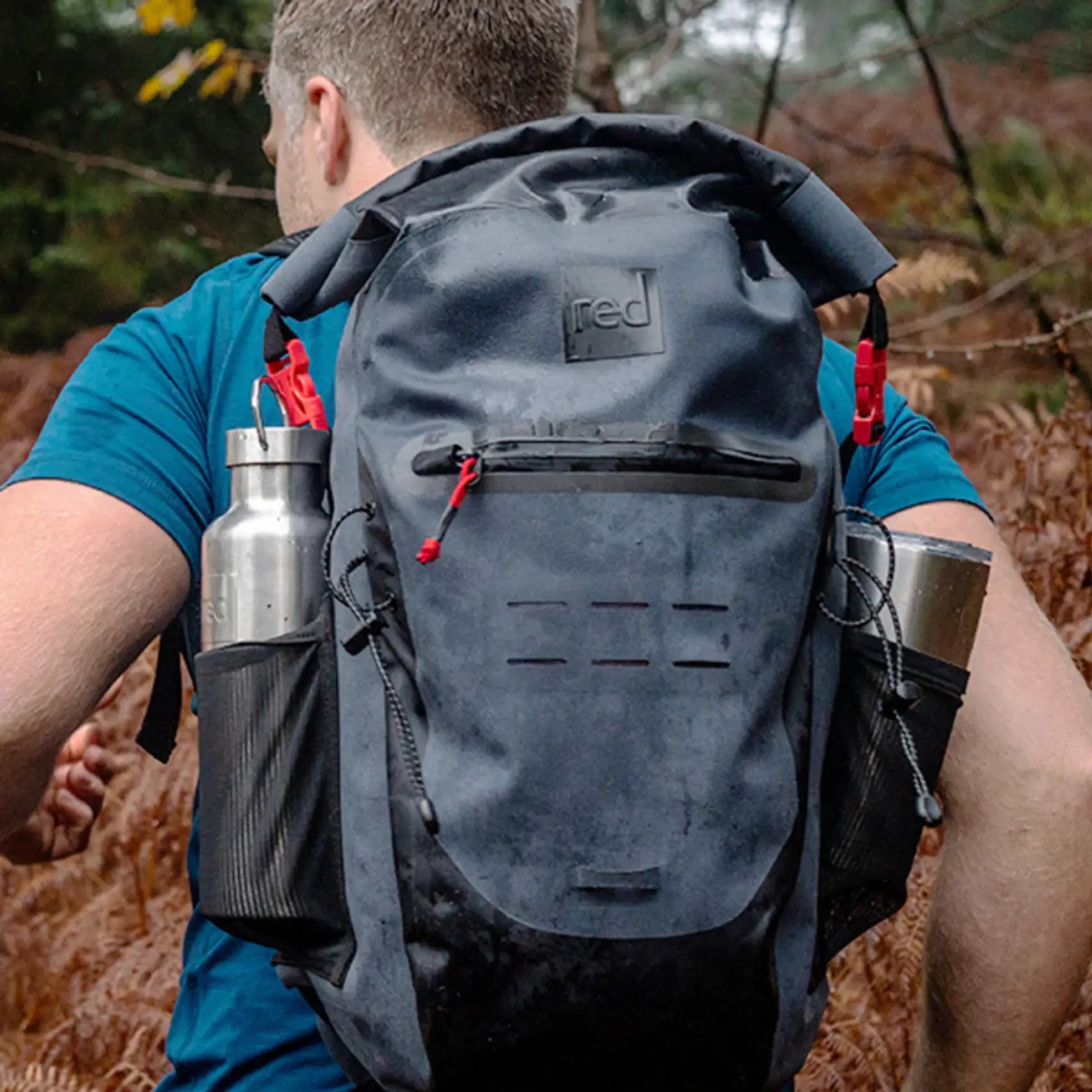 A man wearing a Red backpack, walking